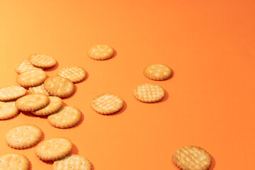 Fototapeta na wymiar Cookies on orange background. Artistic background for pastry or sweet snacks