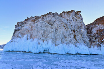 View of Rock Cliffs Covered with Ice and Frozen Lake Baikal During Winter in Siberia