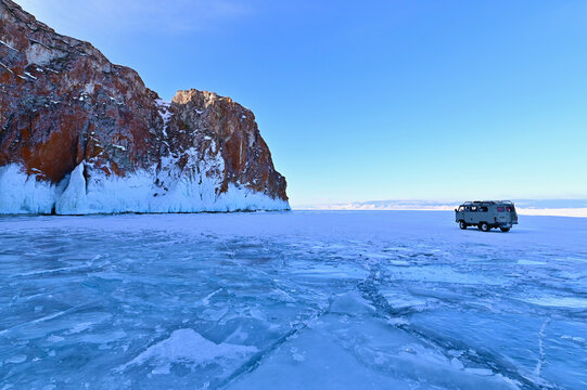 Vintage UAZ 452 or Bukhanka on Frozen Lake Baikal During Sunset
