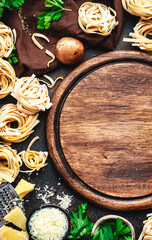 Food background. Uncooked pasta, brown mushrooms, vegetables, cheese and ingredients for tasty cooking on brown table background, top view