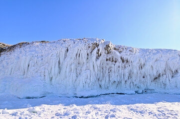 Rock Cliffs on Lake Baikal with Ice Splashes During Winter