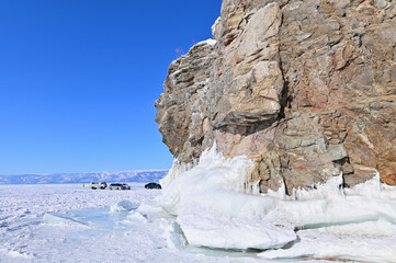 Fototapeta na wymiar Winter Lake Baikal with Rock Cliffs Covered with ice