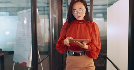 Business, leadership and Asian woman in office, working with team on laptop, tablet and computer in workplace. Success, teamwork and female worker walking, meeting and planning for digital marketing