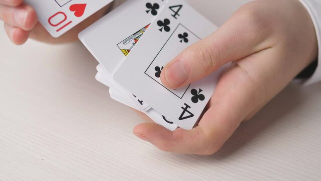 Close hands and a deck of playing cards 4k