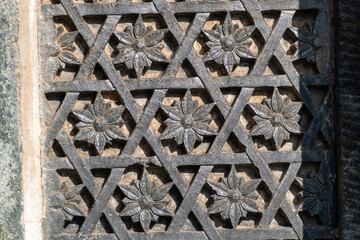 Detail of floral motifs and carvings on the stone walls of the ancient Channakeshava temple in Belur.