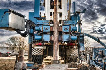 The drilling rig close-up is drilling a well against the background of the cloudy sky. Deep hole drilling. Geological exploration work. mineral exploration. Extraction of gas and oil.