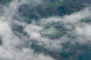 A beautiful Himalayan village covered in mist and fog in the mountains around Munsyari in Uttarakhand.