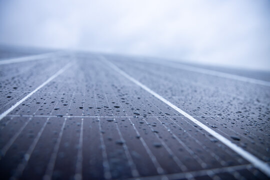 Photovoltaic panel with water pearls on a rainy day 