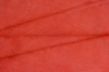 Red suede cut as background textured and wallpaper. Rustic style leather