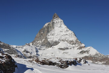 Matterhorn peak in Zermatt in winter with snow and blue sky on a sunny day in the Alps, Switzerland, Europe