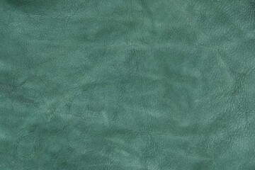 Green leather cut as background textured and wallpaper. Rustic style