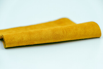 Yellow leather is folded on a white background