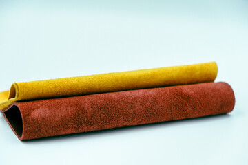 Rolls of natural colorful leather. Materials for leather craft. Red and yellow suede