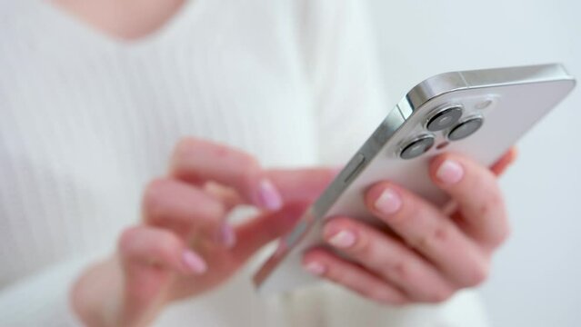 Close up of female hands holding smartphone. Happy mixed race female enjoy online chat, internet purchase, browse web, download new cool freeware application. Modern wireless tech user concept