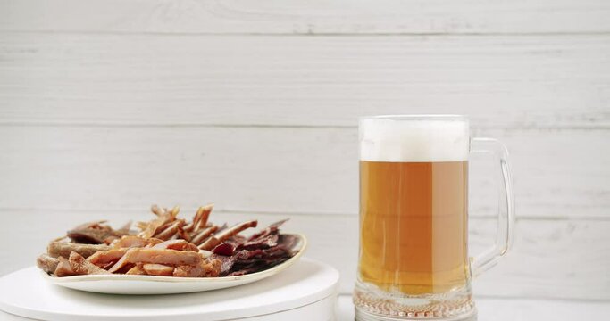 Craft Beer into the large glass. Beer Mug. On a white background. Half a liter, close up. Rotation 360 degrees. Glass full of beer with plate minced meat, and snacks. bbq meat set for beer snack. 