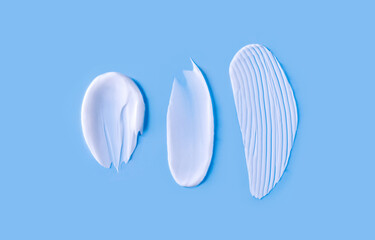 cosmetic smears cream texture on blue background