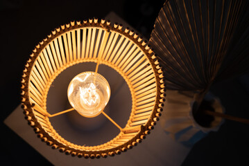 a wooden lamp shines on the table