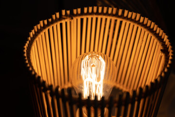 a wooden lamp shines on the table
