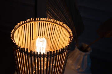 a wooden lamp shines on the table