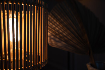 a wooden lamp shines on the table