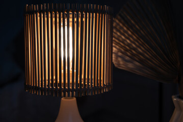 a wooden lamp shines on the table