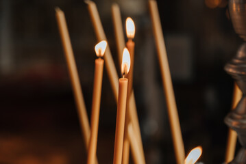 lit candles in the temple close-up