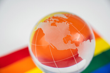 Crystal globe on a rainbow flag. LGBT community.