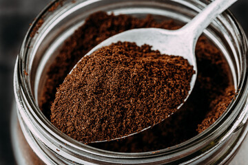 Ground coffee. Ground Coffee in jar on dark background