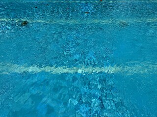 Top view of ripped water in a outdoor swimming pool with texture and reflection.