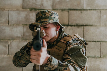 Fototapeta premium A soldier in uniform stands in front of a stone wall in full war gear preparing for battle