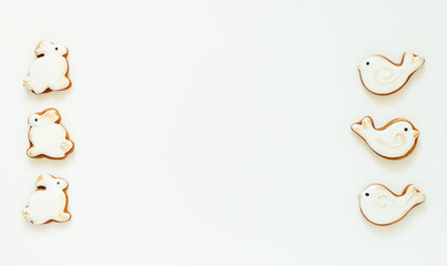 Easter gingerbread in the shape of a bird and a rabbit on a white background. High quality photo. space for text. banner