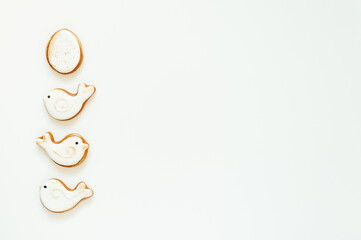 Easter gingerbread in the shape of a bird and a rabbit on a white background. High quality photo. space for text. banner