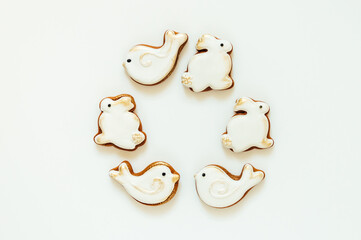 Easter gingerbread in the shape of a bird and a rabbit on a white background. High quality photo. space for text. banner