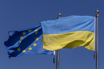 flags of Ukraine and European Union waved on flagpoles