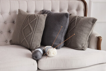 Soft comfortable stylish beautiful knitted pillows and balls of thread