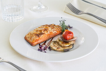 Grilled salmon steak with almond and roast vegetables