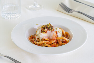 Spaghetti with pecorino cheese and pistachio grain