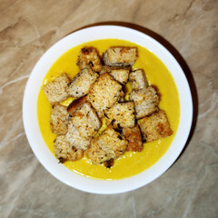 Zucchini puree soup with appetizing fried croutons