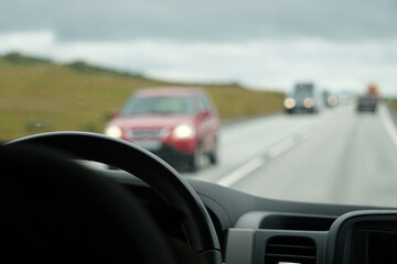 Fototapeta na wymiar Driving a car - perspective of a driver - bokeh effect