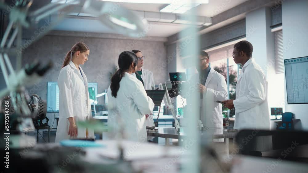 Poster Diverse Team of Industrial Robotics Specialists Gathered Around a Table With a Mobile Robot. Engineers In Lab Coats Discussing an Automated AI Robotic Dog, Using Laptop and Tablet, Brainstorming