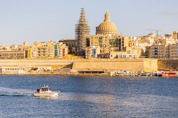 The view on Valletta with a small boat seeing from Manoel Island, Malta, Europe