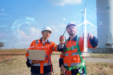 Both of Engineers are controlling a wind turbine with AI technology for precision and accuracy with...
