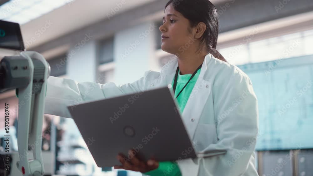 Poster young indian female engineer testing industrial programmable robot animal in a factory development w