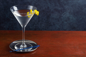 Classic Gin or Vodka Martini Cocktail Shaken with a Lemon Twist on A Wooden Bar	