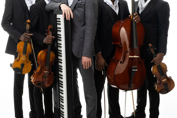 Fototapeta premium Set of musical instruments: violin, cello, piano in the hands of the musicians.