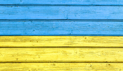 Wood painted in Ukrainian Flag. Bright colors paint on wooden wall. Flag of Ukraine. Blue and yellow country symbol colors. Simple banner background.
