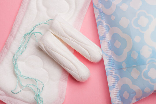 Menstruation concept, sanitary pads and tampons on pink layout, gynecology background