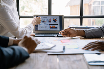 Businessmen team or financial data analysts working with tablets and laptop computers and data graphs together. Plan to analyzing projects in the office.