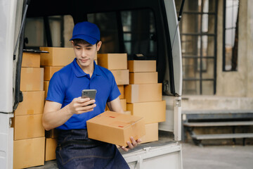 Asian delivery man using smartphone contacted a customer asking for a shipping address.