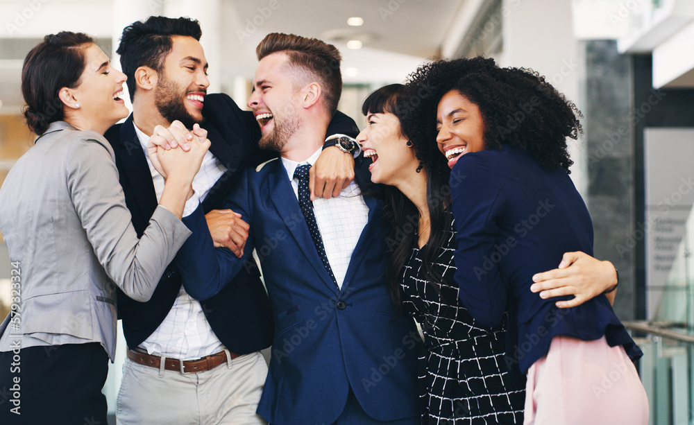 Poster the team that laugh together stick together. cropped shot of a diverse group of businesspeople huggi